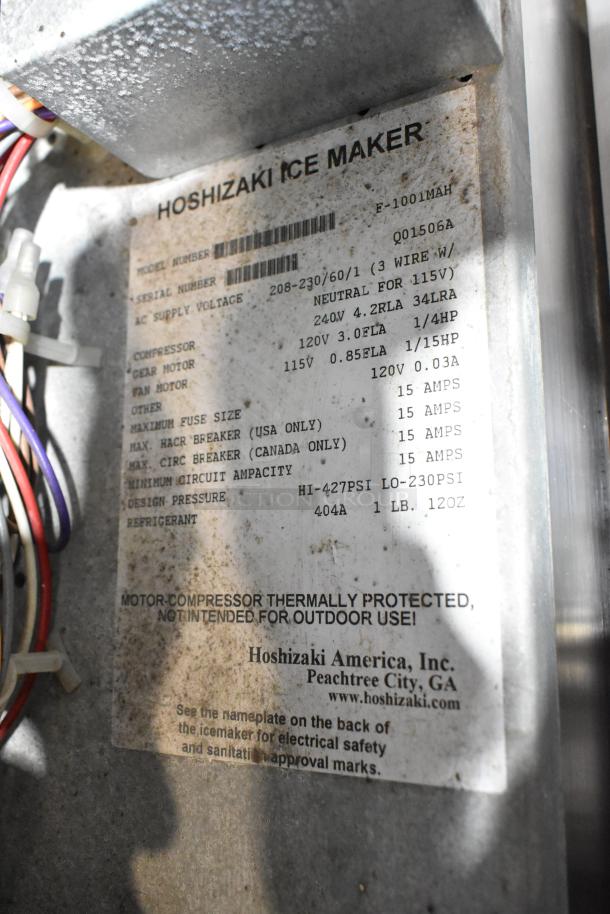 Hoshizaki F-1001MAH commercial ice maker, 208-230V, 1 phase, serial Q01506A, mounted on an ice bin, marked for 404A refrigerant.