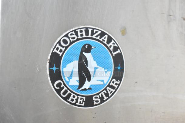 Hoshizaki Cube Star logo on metal surface, part of Hoshizaki F-1000MRB commercial ice head unit.