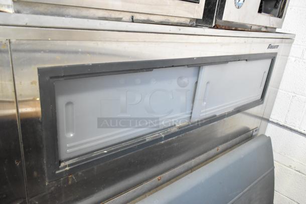 2 Hoshizaki F-1000MRB metal ice heads on Follett LSG1 ice bin, 208-230V, 1 phase, in used condition, industrial setting.