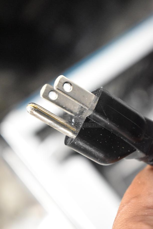 Close-up of a black three-prong electrical plug for a Halsey Taylor HTHBHACG8NF_1D water fountain, 115 volts, 1 phase.