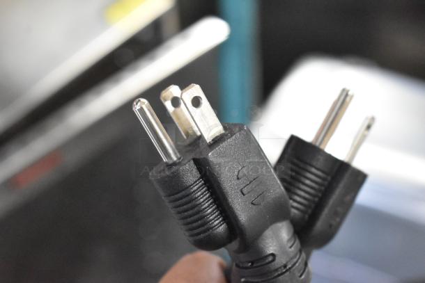 Close-up of a 120-volt electrical plug for the Avantco 177PG400 commercial panini grill, showing three prongs.