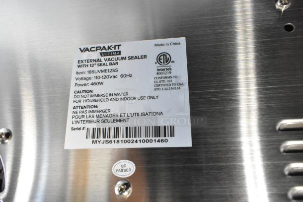 Brand new VacPak-It Ultima UVME12SS vacuum packing machine with 12" seal bar, roll cutter, dual piston dry pump; label shows specs.