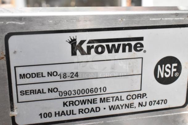 Krowne 18-24 stainless steel ice bin, missing two legs, with model and serial number label visible.