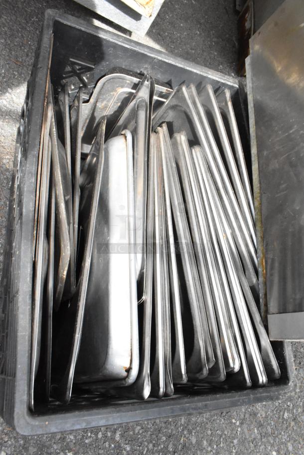 Lot of various metal full-size drop-in bin lids in a black crate, showing signs of minor wear.