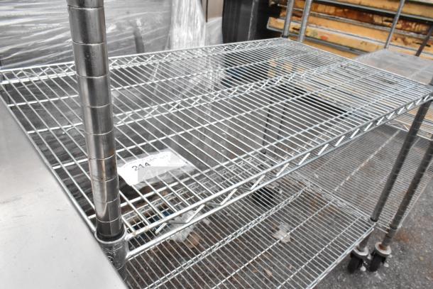 Chrome finish 3-tier wire shelving unit on commercial casters, sturdy condition, dismantling required, freight charges apply.