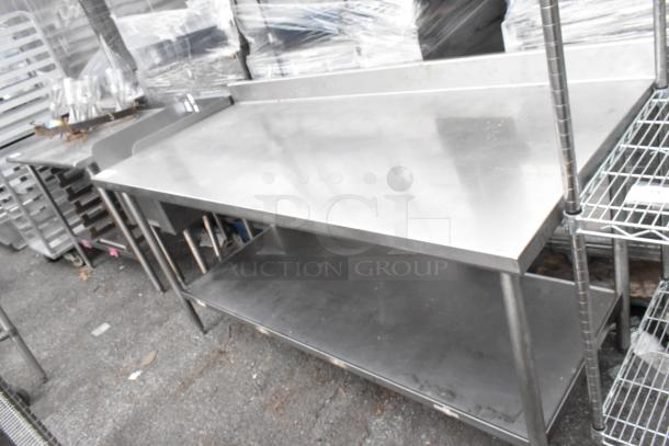 Stainless steel table with under shelf, used condition, ideal for commercial kitchens, stable metal construction.