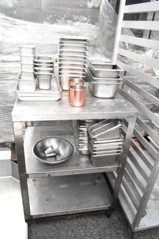 Metal 3-tier cart with commercial casters, containing assorted stainless steel drop-in bins and copper mugs.