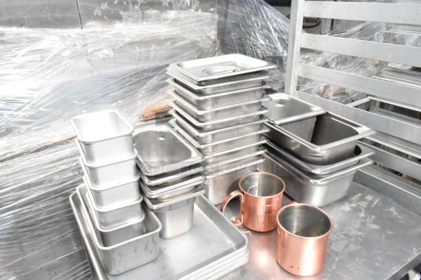 Metal 3-tier cart on commercial casters with stacked stainless steel drop-in bins and bronze mugs. Clean and organized.