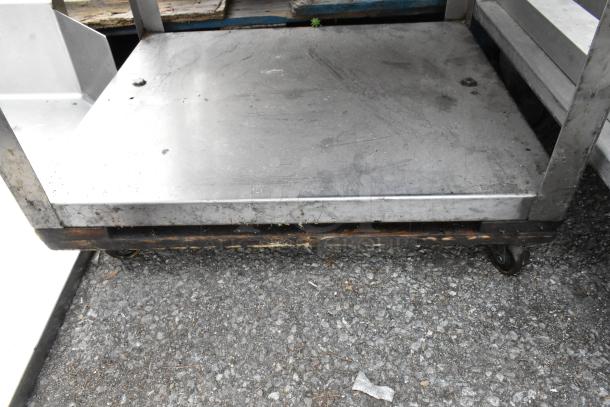 Metal 3-tier cart with commercial casters, includes stainless steel drop-in bins. Slight wear visible on surfaces.