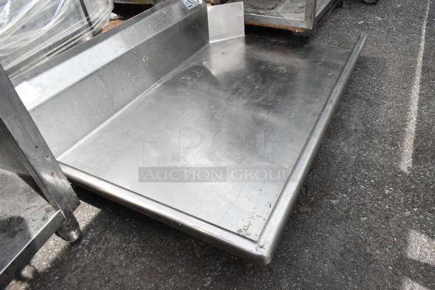 Alt text: Advance Tabco DTC-S30-48L stainless steel dishwasher table, left side clean, missing legs, showing minor wear.