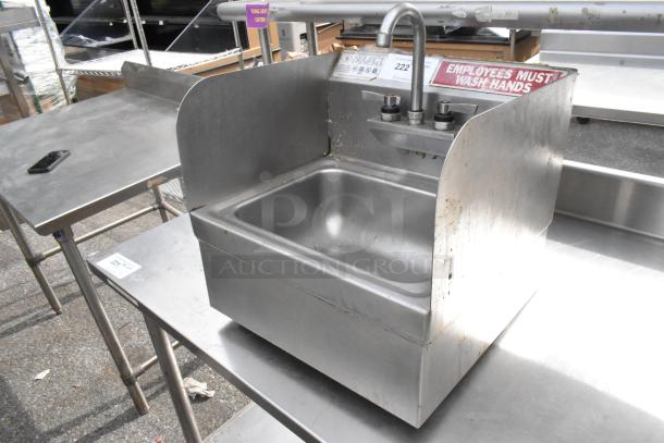 Stainless steel wall mount sink with faucet and dual handles, used condition, "Employees Must Wash Hands" sign.