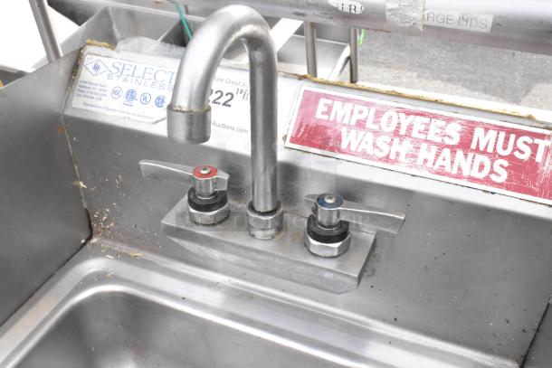 Stainless steel single bay wall mount sink with faucet, dual handles. Slight wear, "Employees Must Wash Hands" sign visible.