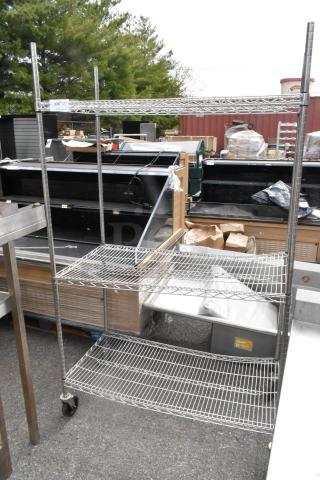 Chrome finish 3-tier wire shelving unit on commercial casters, excellent condition, includes notice on dismantling and shipping.