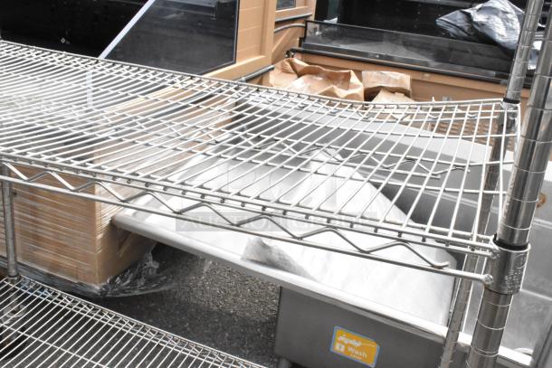 Chrome finish 3-tier wire shelving unit on commercial casters, durable and movable. Buyer must dismantle.