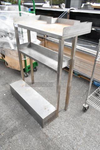 Metal table with under shelf, used condition, stainless steel, some surface rust, ideal for industrial use.