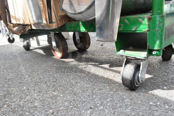 Uline green metal U-boat cart on casters, containing sous vide and metal chafer frame. Visible wear on surfaces.