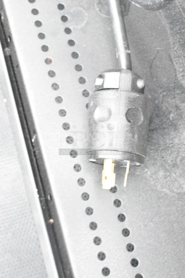 Close-up of a power plug for the 2018 Killion PFW-74-46-48-V-N-MOBILE merchandiser, showing details of the connector.
