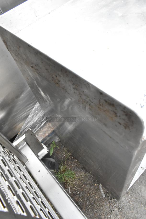 Stainless steel table with drop-in bins and metal bowls included, showing some rust and signs of wear.
