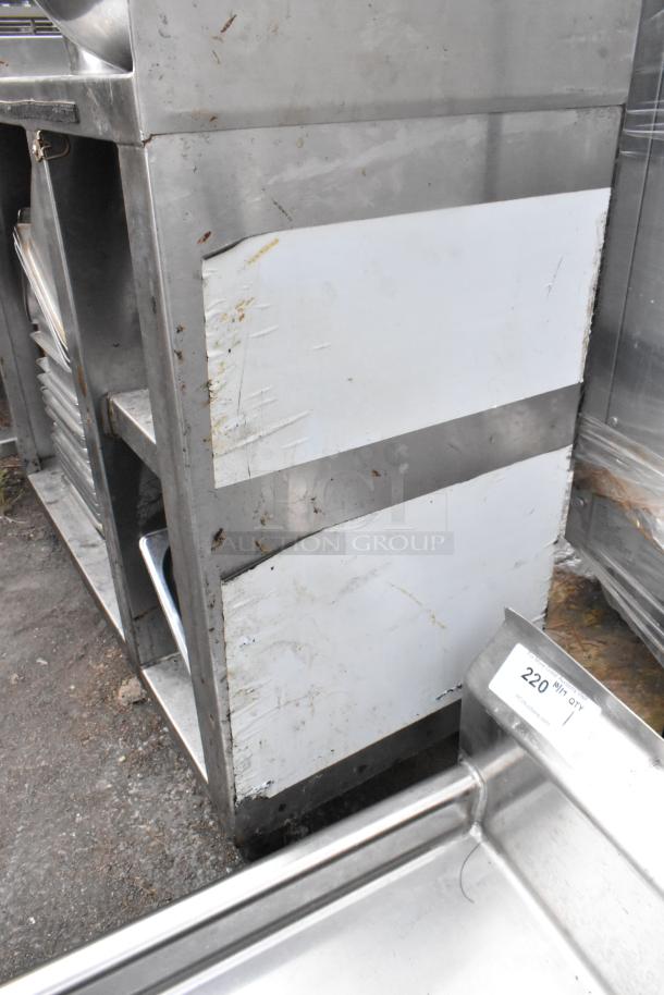 Stainless steel table with drop-in bins, metal bowls, some surface wear, and a labeled bin marked "220."