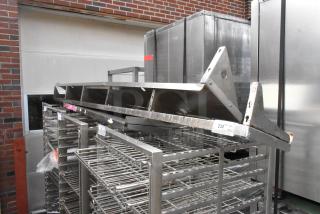 Two metal wall mount shelves, sturdy design, slight surface wear, suitable for industrial use. Includes labels indicating lot number 232.