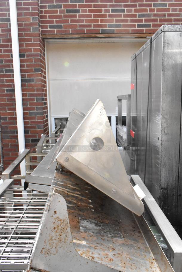 Two metal wall mount shelves with triangular supports, showing signs of rust, suitable for industrial use.