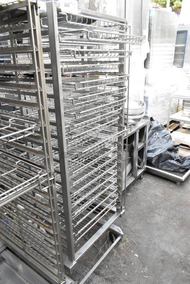 Metal commercial pan transport rack with wire shelves on casters, used condition. Ideal for kitchen storage and transport.