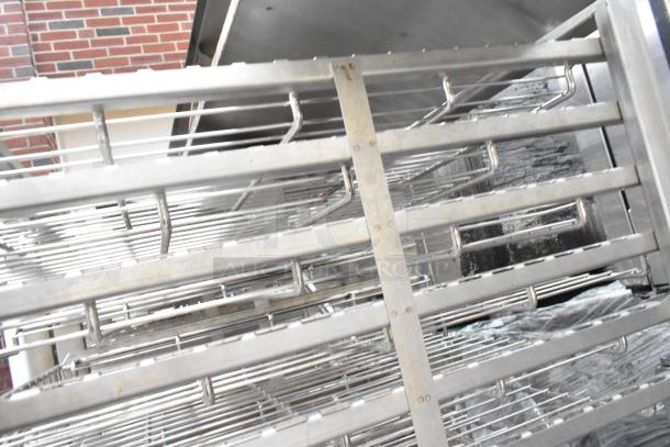 Metal commercial pan transport rack, features wire shelves on durable commercial casters, excellent condition.