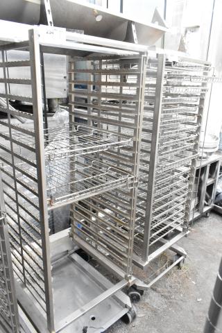 Metal commercial pan transport rack with multiple wire shelves, set on durable commercial casters, ideal for kitchen use.