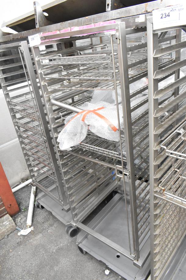 Metal commercial pan transport rack with wire shelves, mounted on commercial casters. Ideal for kitchen use.