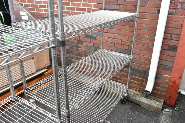 Chrome finish 5 tier wire shelving unit with commercial casters. Good condition. Buyer must dismantle.
