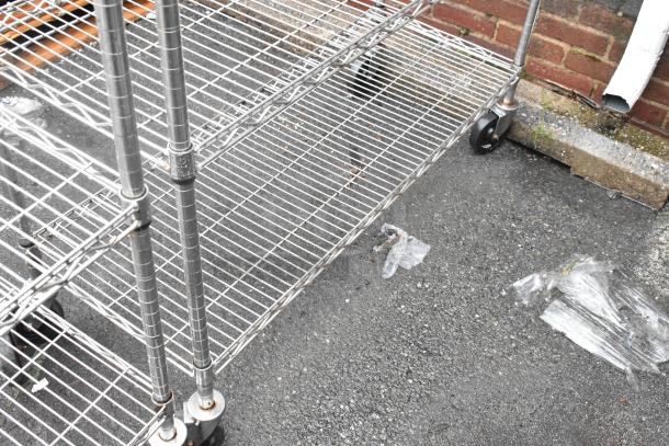 Chrome 5-tier wire shelving unit on commercial casters, in used condition. Buyer must dismantle; consider freight charges.