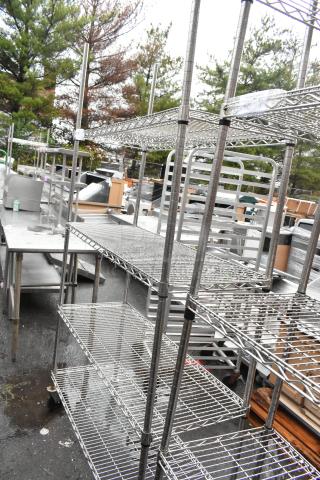 Chrome finish 4-tier wire shelving unit on commercial casters, outdoor setting, buyer must dismantle, freight charges apply.