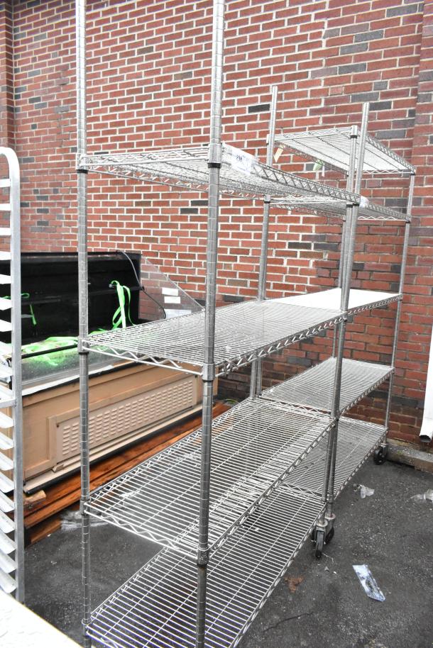 Chrome finish 4-tier wire shelving unit on commercial casters, in good condition. Buyer must dismantle; freight charges apply.