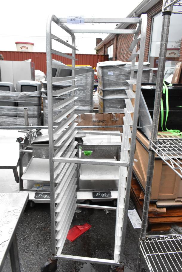 Metal commercial pan transport rack on industrial casters. Sturdy construction, capable of holding multiple pans. Slight wear.