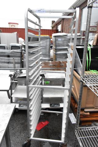 Metal commercial pan transport rack on industrial casters. Sturdy construction, capable of holding multiple pans. Slight wear.