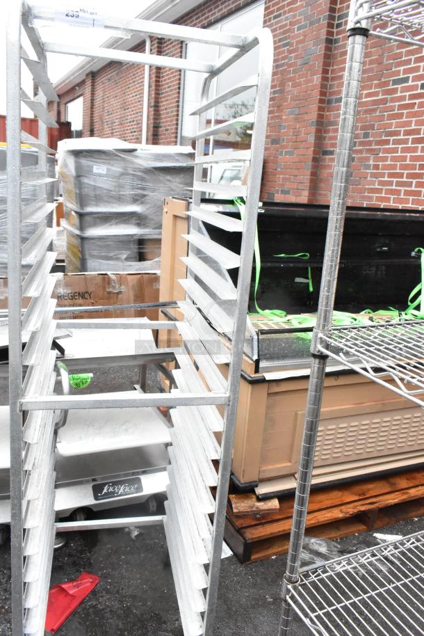 Metal commercial pan transport rack on casters, sturdy frame, multiple shelves, ideal for kitchens, shows minor wear.