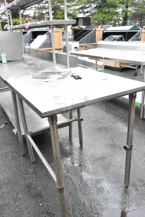 Stainless steel table with tubular legs, light wear. Suitable for commercial kitchens, durable surface, no noticeable markings.