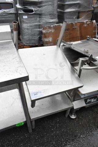 Metal 2 tier shelf with sturdy legs, used condition, slight surface wear. Auction tag indicates item 243.