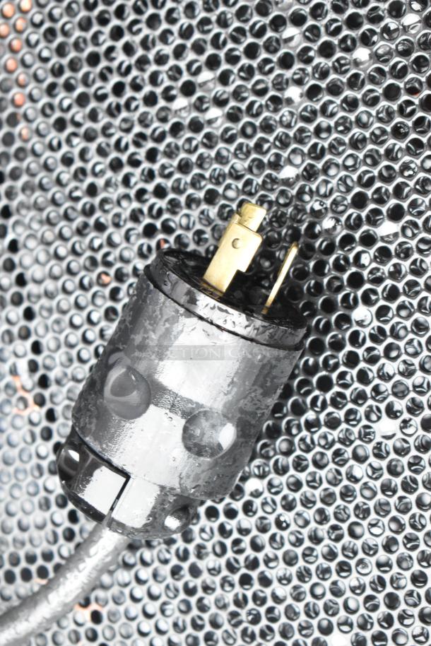 Black, heavy-duty electrical plug against a perforated metal surface, part of Killion merchandiser model PFW-74-43-48-V-N-MOBILE.