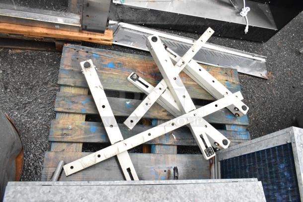Two metal commercial condensers with assorted metal pieces on a wooden pallet. Suitable for industrial use, sold as is.