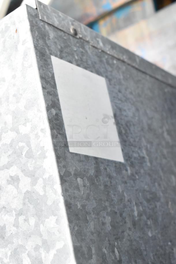 Two metal commercial condensers with additional metal pieces, showing galvanized steel texture, in good condition.