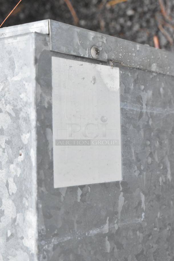 Two metal commercial condensers with visible metal casing and screws, showcased in industrial condition.