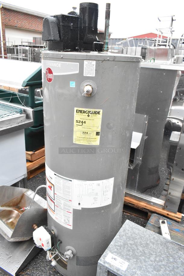 Rheem XG50T06PV42U0 commercial natural gas water heater in metal casing, includes visible labels and energy guide tag.