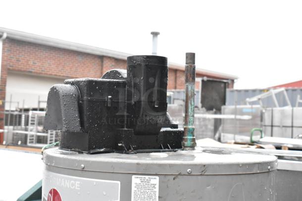 Rheem XG50T06PV42U0 commercial natural gas water heater, metal exterior, seen with moisture and labels, in used condition.