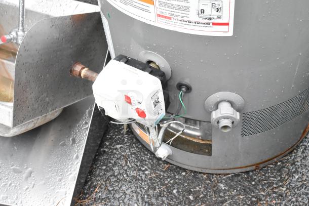 Rheem XG50T06PV42U0 natural gas water heater with visible gas line and control panel, in good condition.