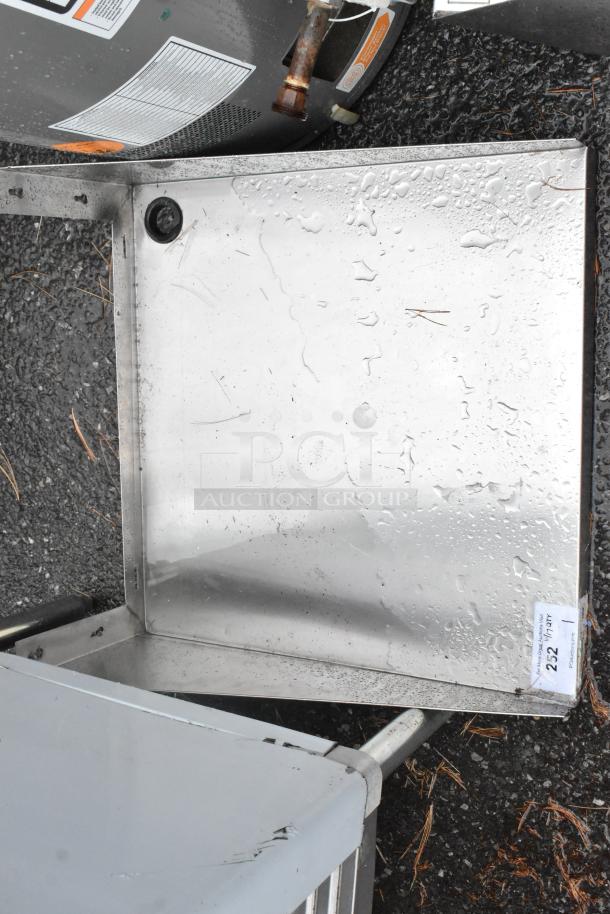 Regency 600MS2424 stainless steel wall mount shelf, shown outdoors, used condition, with visible rust and water droplets.