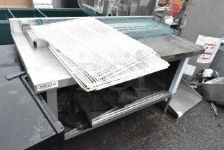 Steelton 30"x60" stainless steel table with 4" backsplash, sliding doors, and enclosed base. Includes contents.