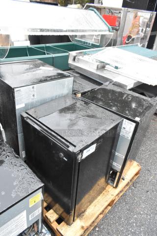 Four mini coolers including Galanz GLR31TS1E02 and Haier HC27SW20RB models on a pallet, wet exterior, auction item.