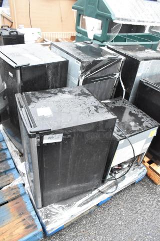 Four mini coolers on pallets, including Arctic King AFRM026AEB and Haier HC32TW10SB. Used condition, visible labels.