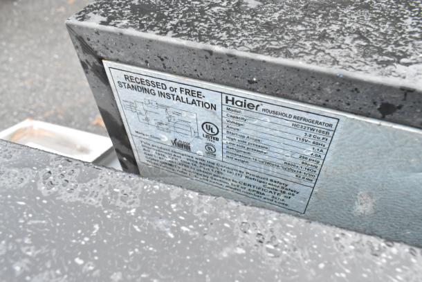 Haier mini cooler label with model HC32TW10SB, 3.2 cu.ft capacity, 115V, 1.1A. Suitable for recessed or free-standing installation.
